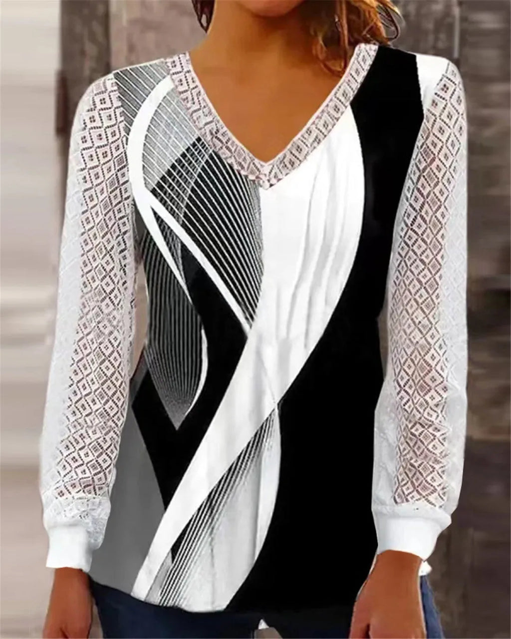 Purple loose fit V-neck lace top with long sleeves and hollow-out detail on a hanger.
