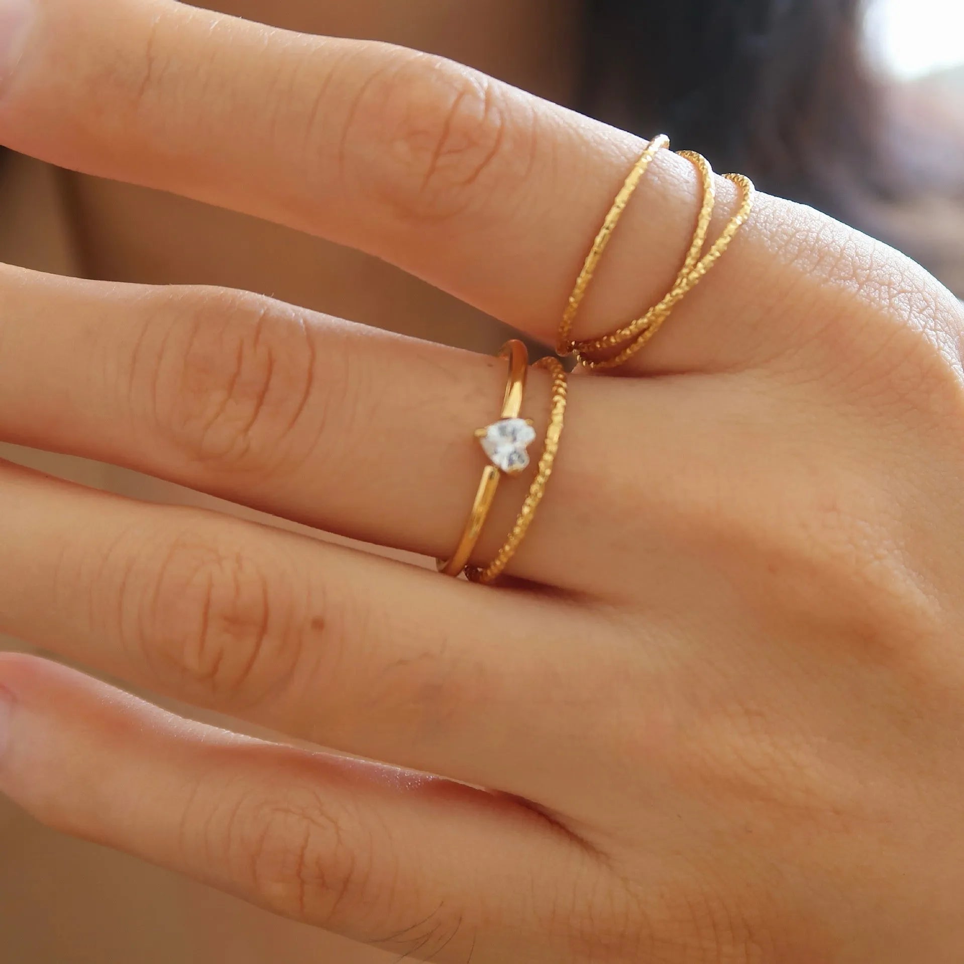 Golden stainless steel ring showing heart shape and oval style options for women in multiple sizes