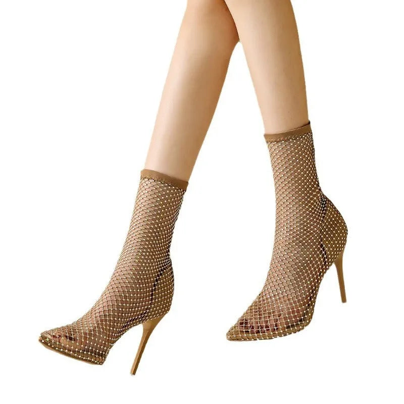 Gold women's pointed toe stiletto high heel sandals with mesh uppers on a white background
