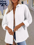 Women's solid colour long sleeve knit cardigan sweater in black, shown on a model.