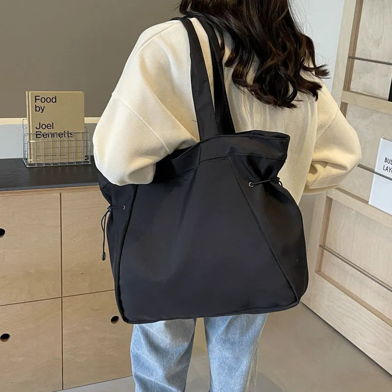 Oxford cloth folding shoulder tote bag in a choice of five colours including black, brown, and purple.