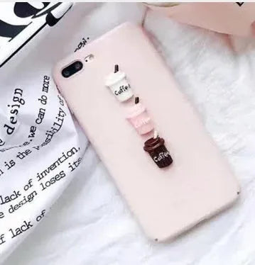 Soft silicone iPhone case with a raised 3D cartoon cat design, shown in pink.