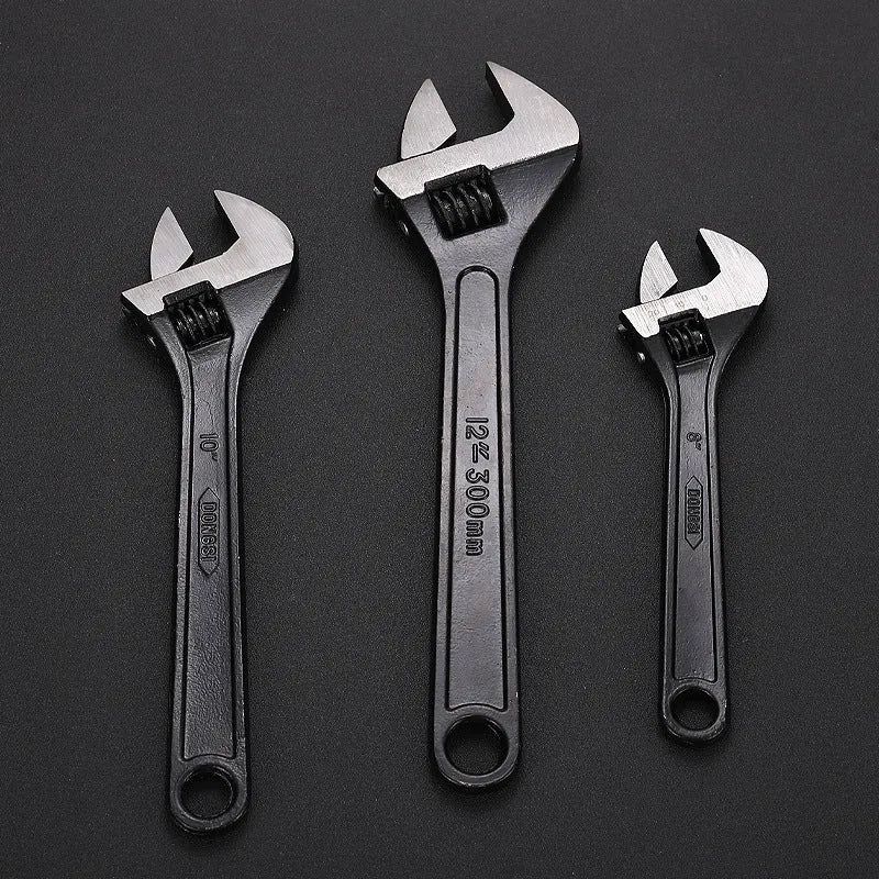 High-carbon steel adjustable spanner with black finish on a grey background.