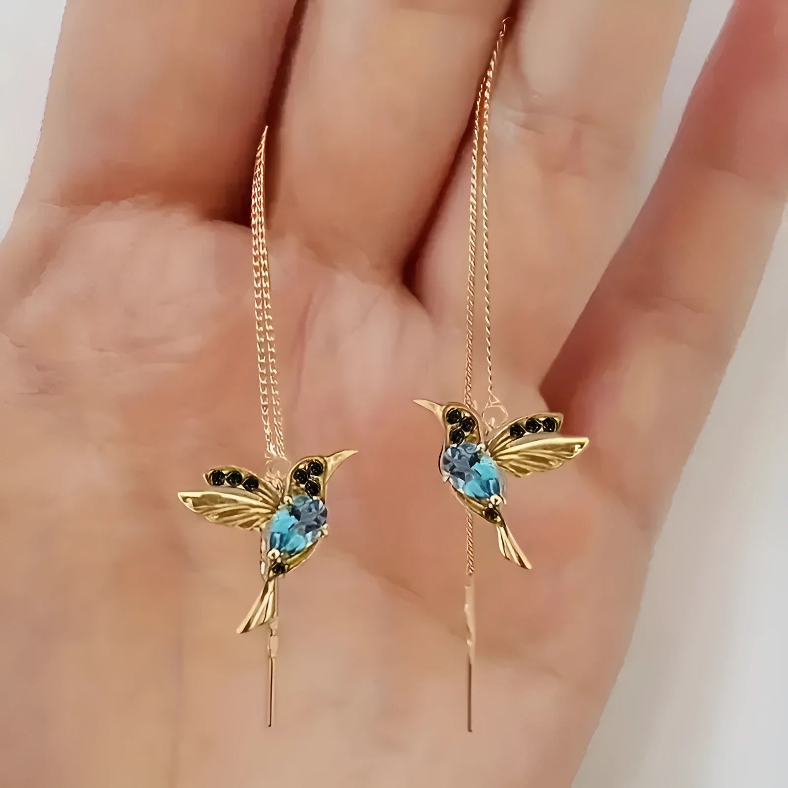 Personalised bird hanging earrings with zirconium wing detail and zodiac animal modelling in long drop style