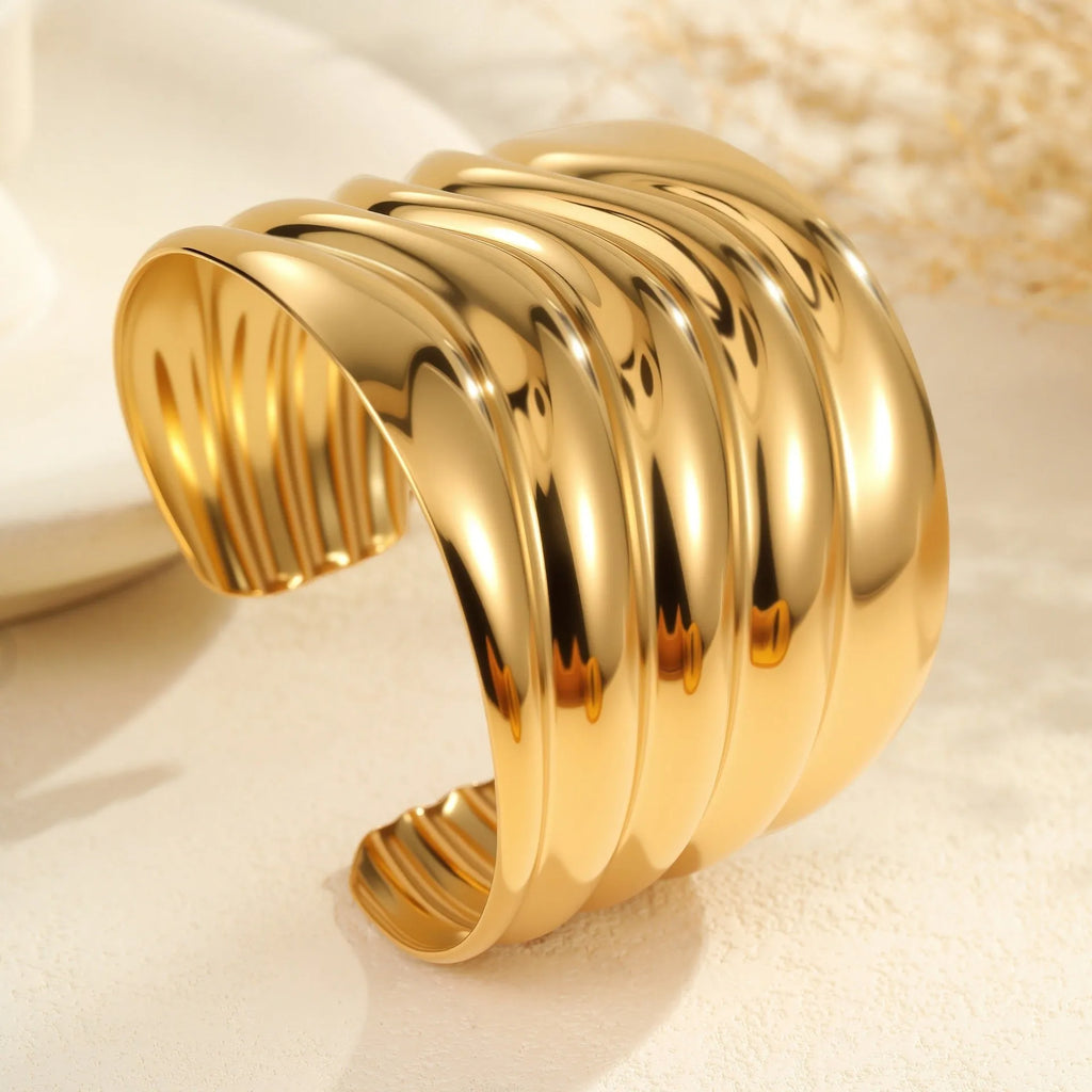 Women's wide wave design bracelet with geometric openings and gold plating finish