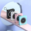 Mini clock charger power bank with LCD screen in mint green colour showing the time.