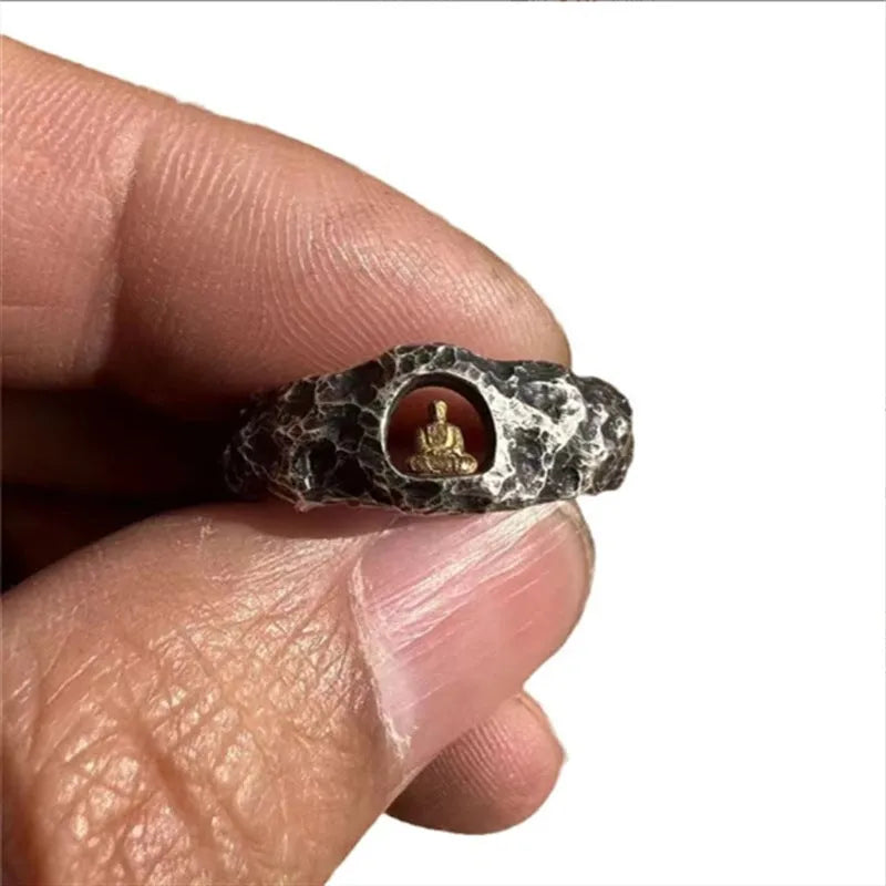 Hand-forged copper Buddha ring with rock texture finish showing grotto design