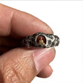Hand-forged copper Buddha ring with rock texture finish showing grotto design