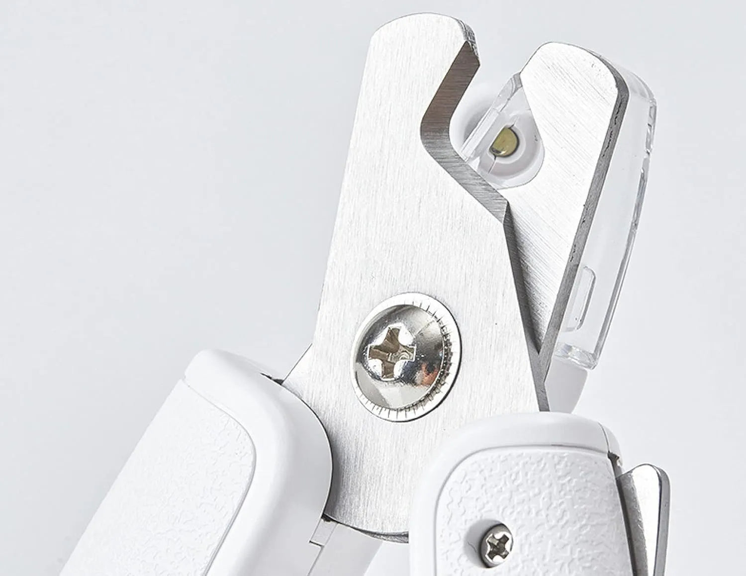White pet nail clippers with LED light and transparent splash guard open, showing the triangular steel blade.