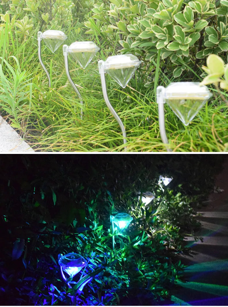 White solar-powered diamond-shaped garden spotlight with adjustable head on a stake for outdoor installation.