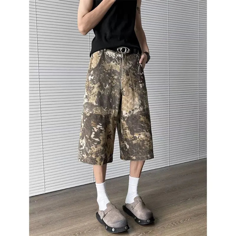 Yellow women's cropped jeans with a bold snake and camouflage pattern print on the legs.