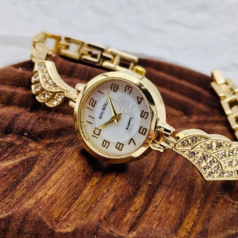 Women's stainless steel watch with round dial in gold, black gold, or white gold finish.