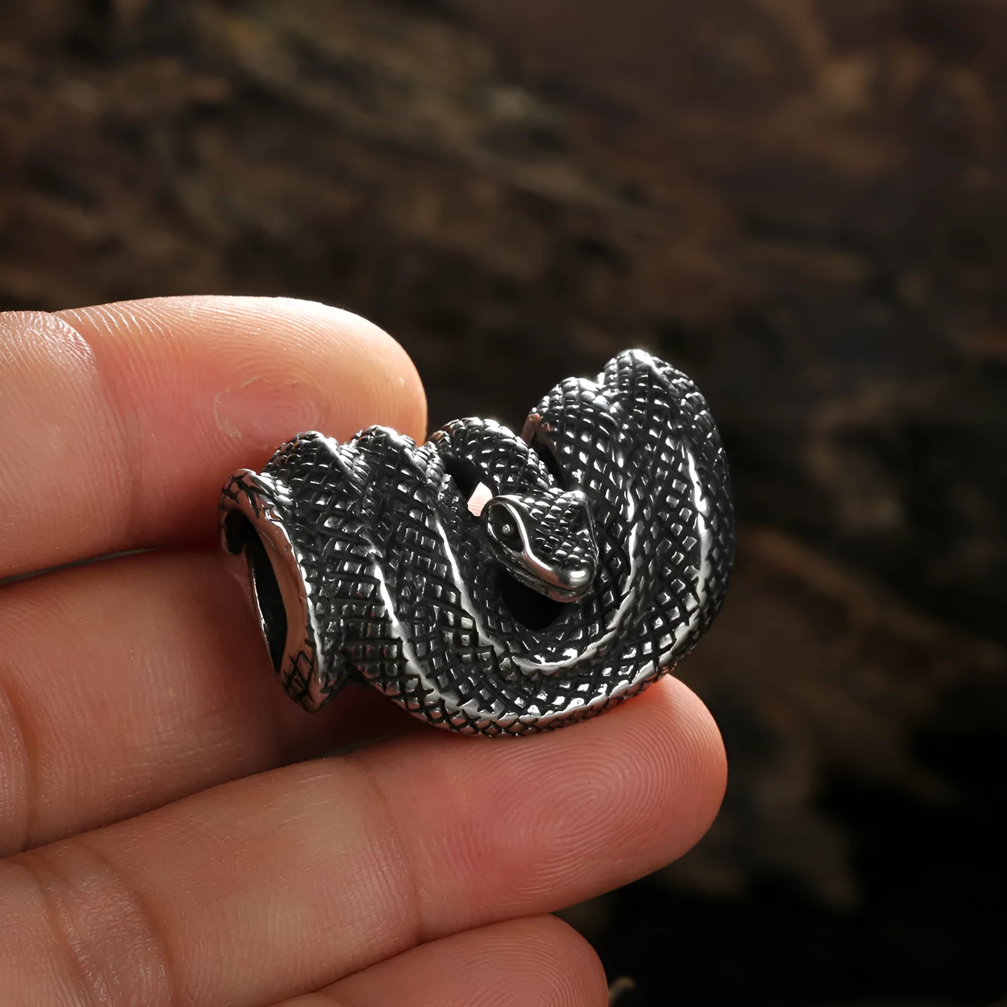 Geometric stainless steel Python pendant necklace in single pendant steel colour on a plain background