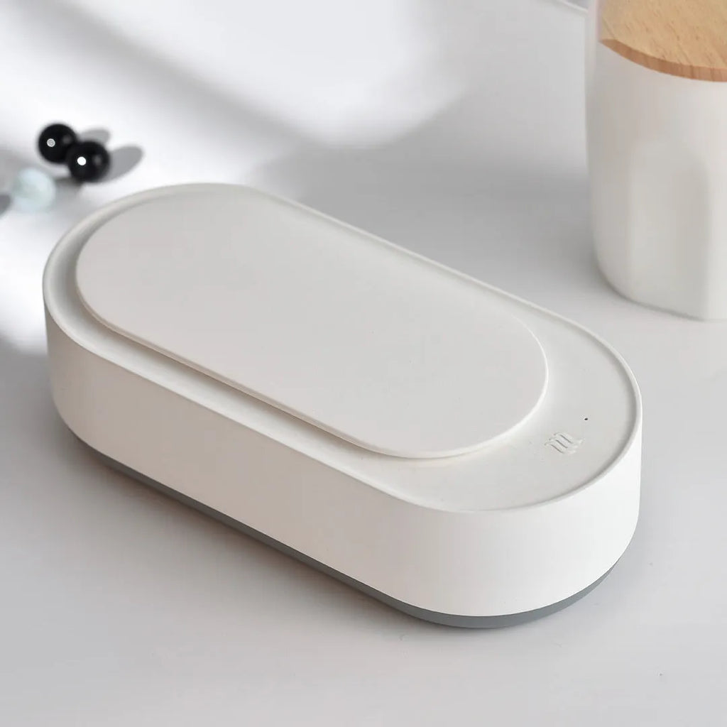 White portable ultrasonic cleaning machine with stainless steel tank for jewellery and glasses.