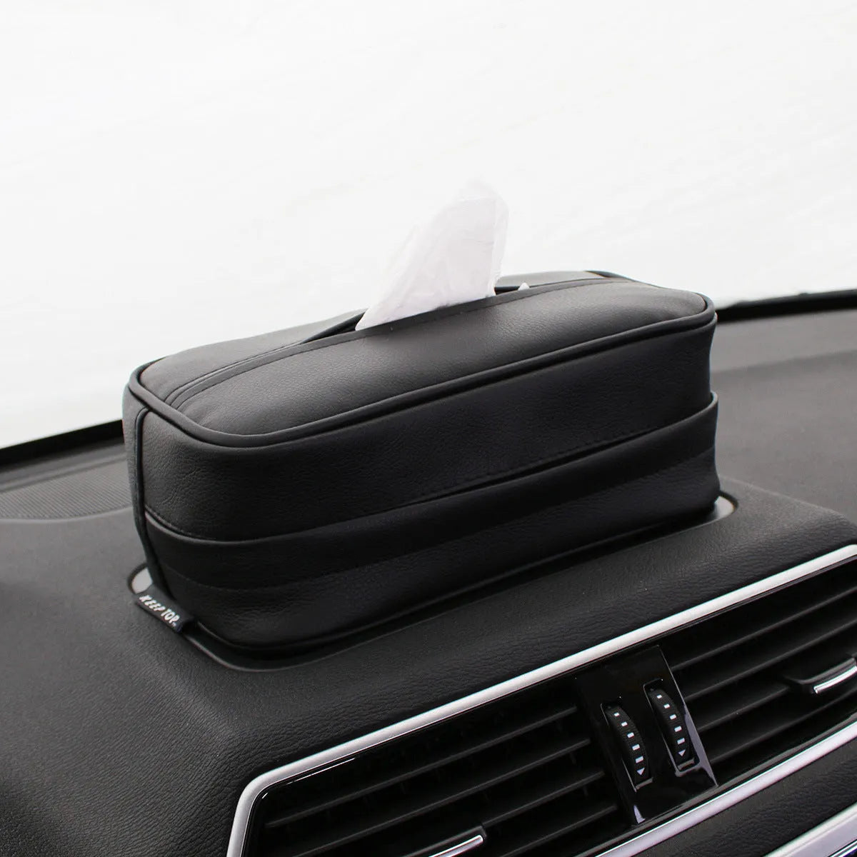 Black leather hanging organiser bag with zip and two loops, shown next to a beige version.
