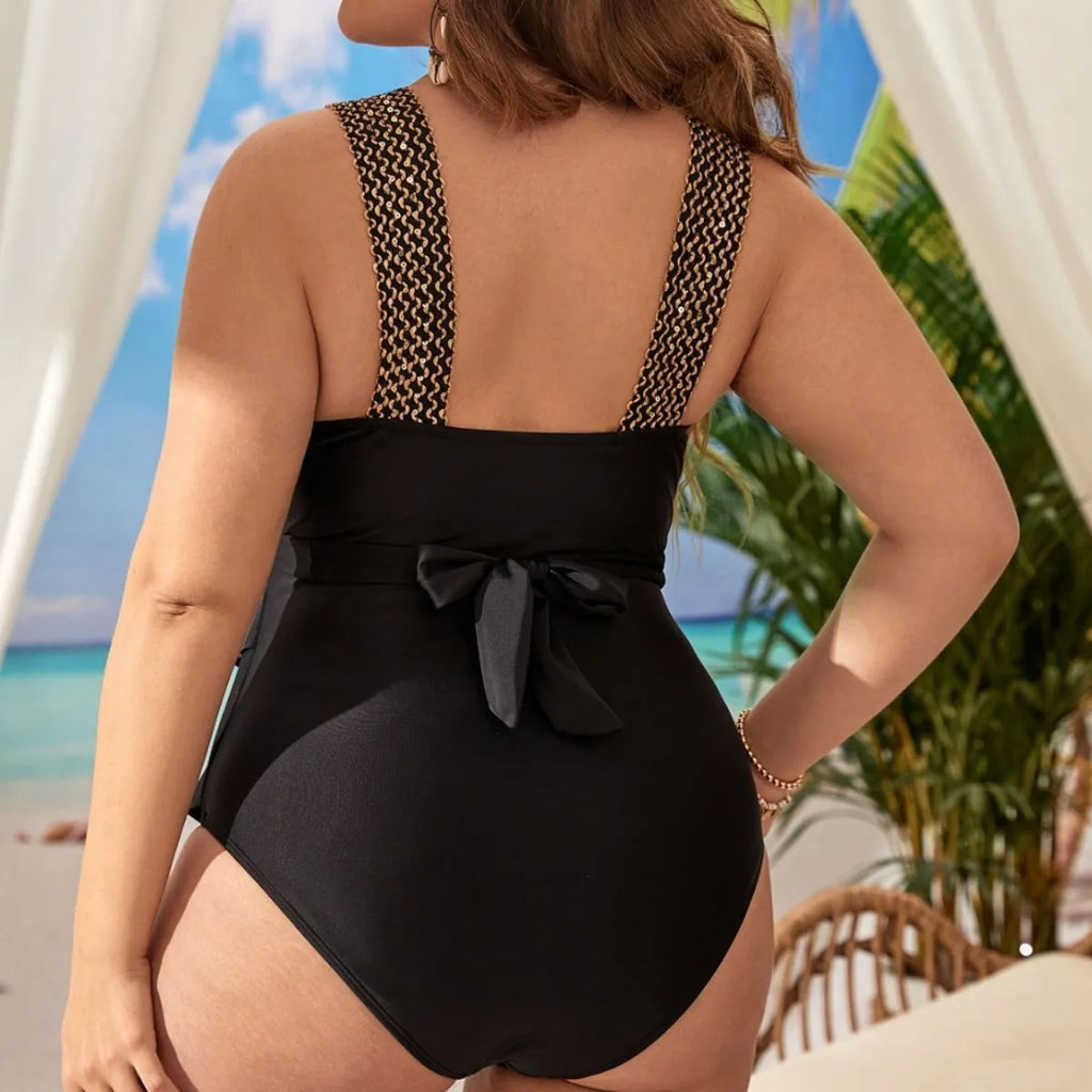 Women's black plus-size one-piece sleeveless swimsuit with built-in chest pad on a hanger