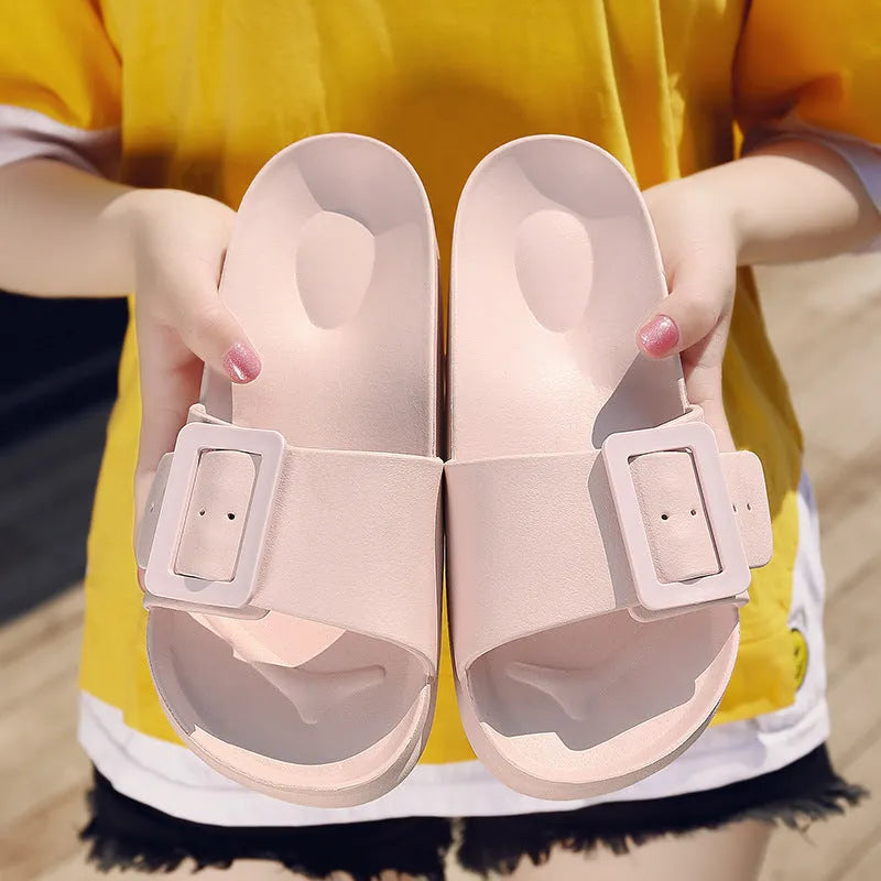 Women's grey blue buckle slippers with a soft EVA sole and single buckle closure.
