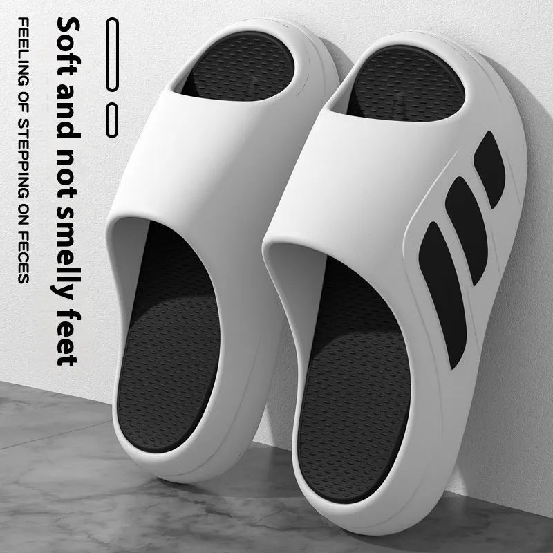 Men's and women's brown EVA platform slippers with a letter detail on the upper, shown on a white background.