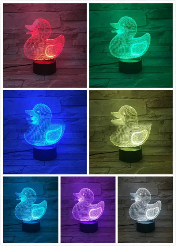 Yellow 3D duck-shaped LED night light on a table with remote control, showing multi-colour glow.