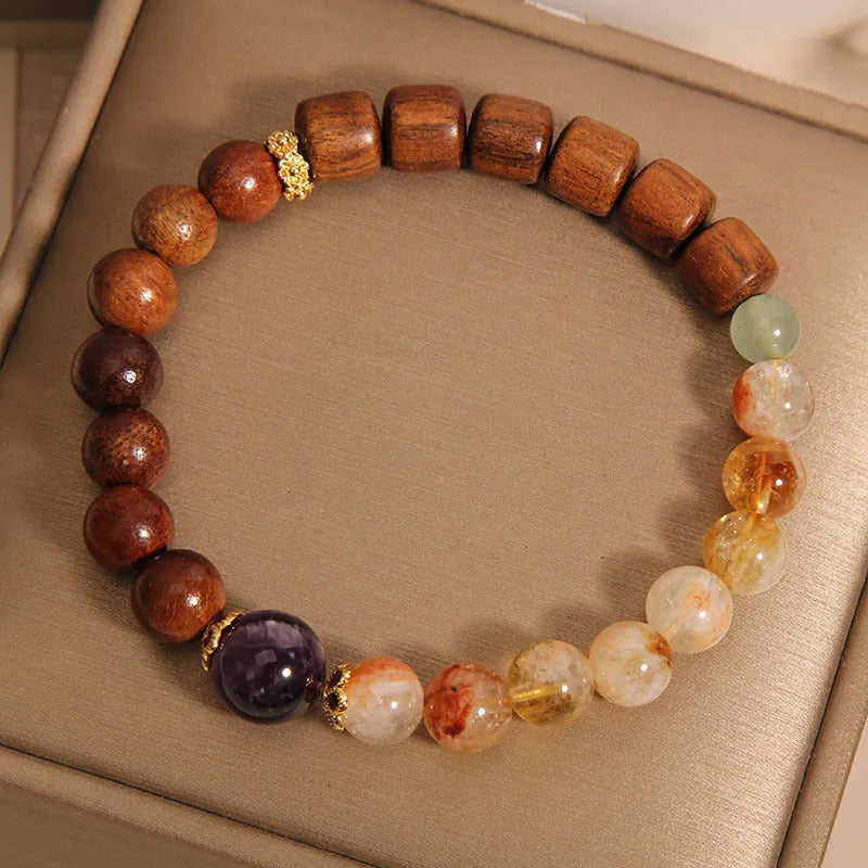 Women's bracelet with yellow crystal, amethyst, ebony, pearls, and rhinestones.