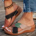 Women's black cross-strap peep-toe slippers with a thick sole, shown from the side.