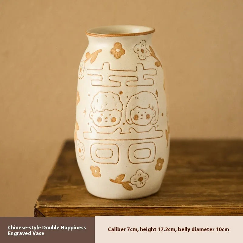 Chinese hand-painted ceramic joy vase with carved detail on desktop