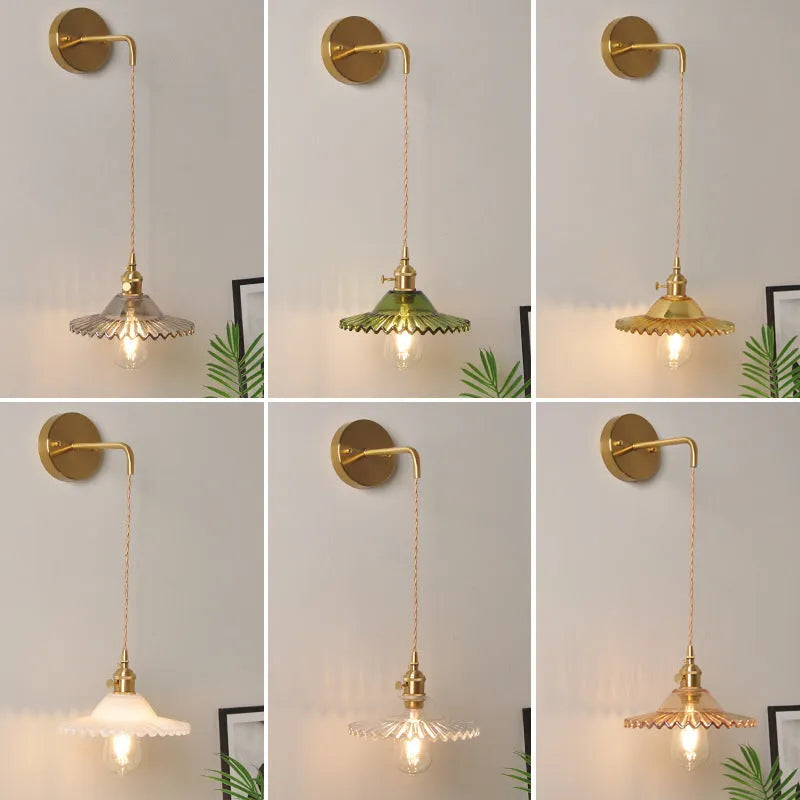 Brass lotus wall lamp with glass shade in six colour options on a wall