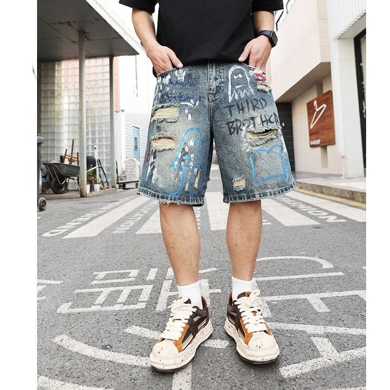 Blue ripped men's denim jeans shorts with graffiti patterns and straight-leg style