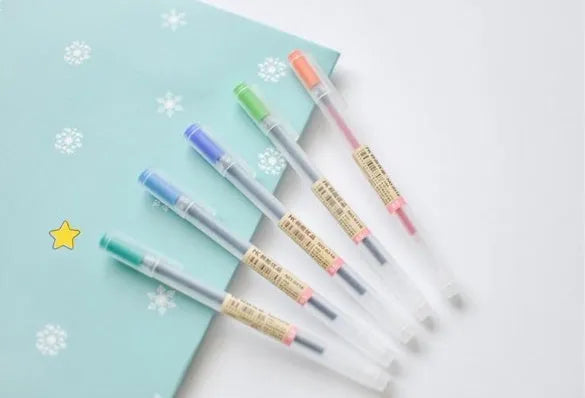 Set of twelve black Muji gel pens with 0.5mm fine tips, shown with caps off.