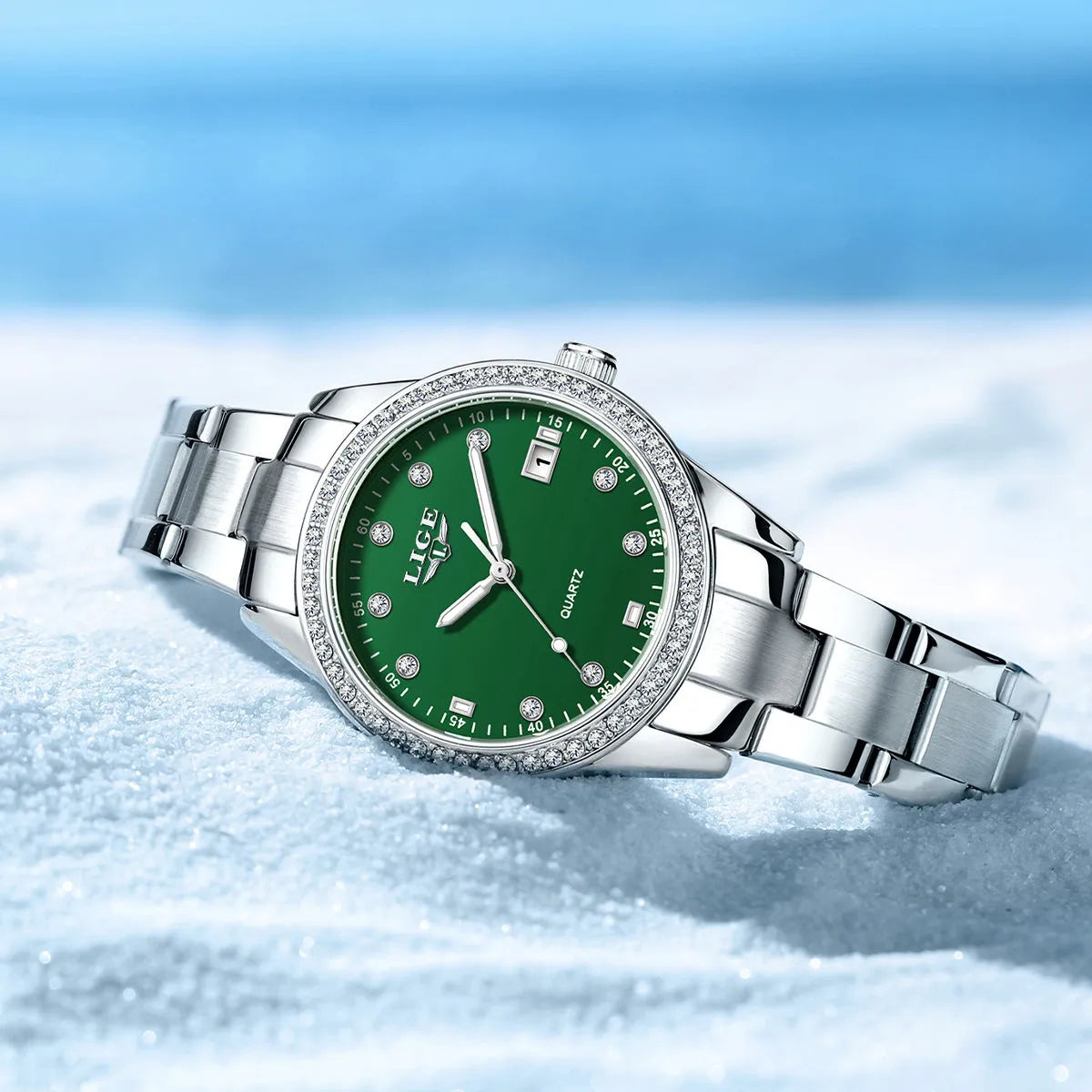 Silver fashion quartz watch for women with diamond-encrusted bezel and luminous dial on a 34mm stainless steel case.