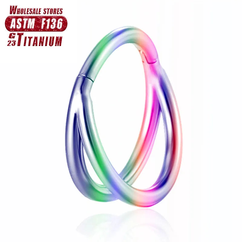 Titanium alloy nose ring jewellery on a plain background showing silver and gold colour options.