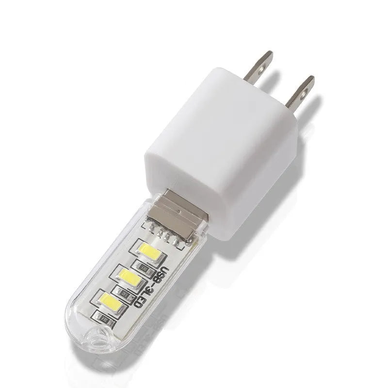 Small white USB-powered LED baby night light with eye protection, shown next to a USB cable for scale.