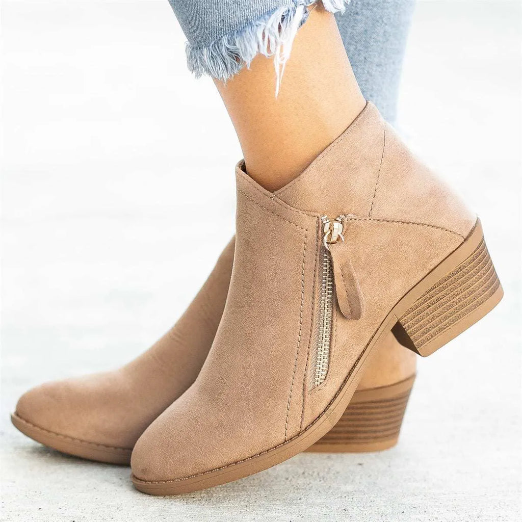 Women's ankle boots in suede with a side zip and chunky heel, shown in beige colour.