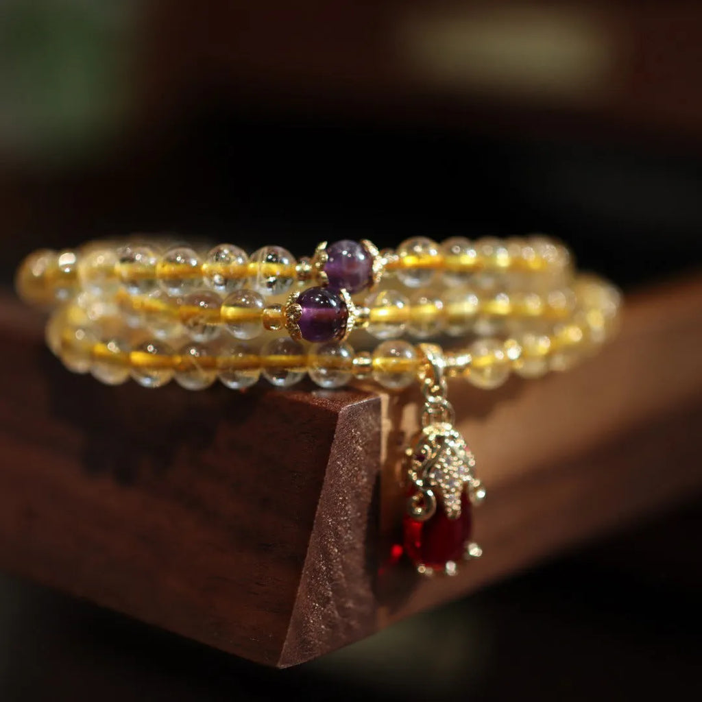 Brazil gold rutilated quartz bracelet with three golden circles and ruby quartz hanging chopsticks