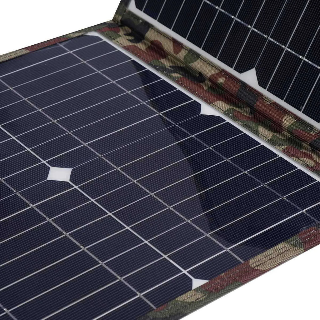 Black foldable 36W solar panel unfolded showing three monocrystalline silicon cells with car charger and USB accessories