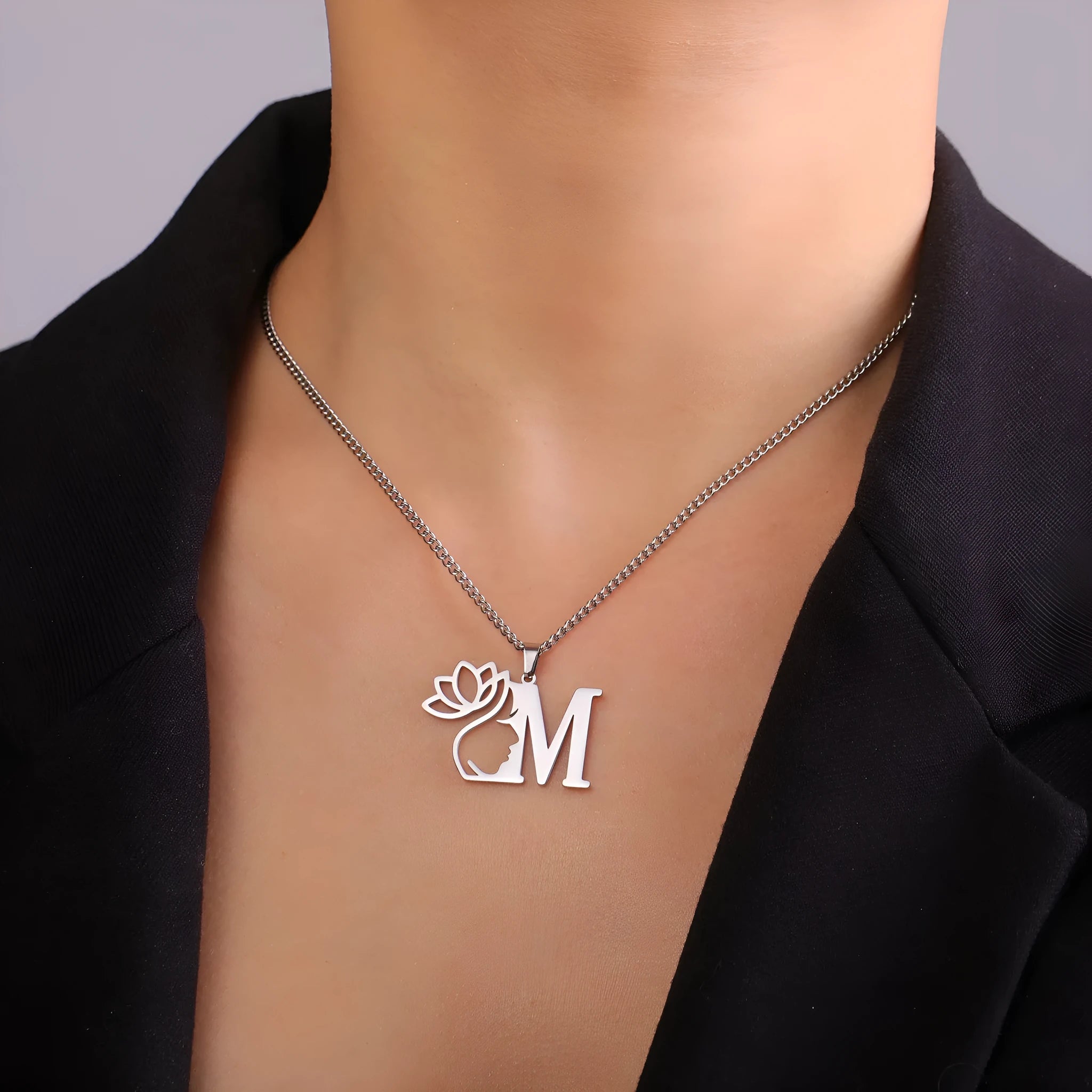 Stainless steel fashion necklace with cross chain and single pendant in gold or silver electroplated finish.