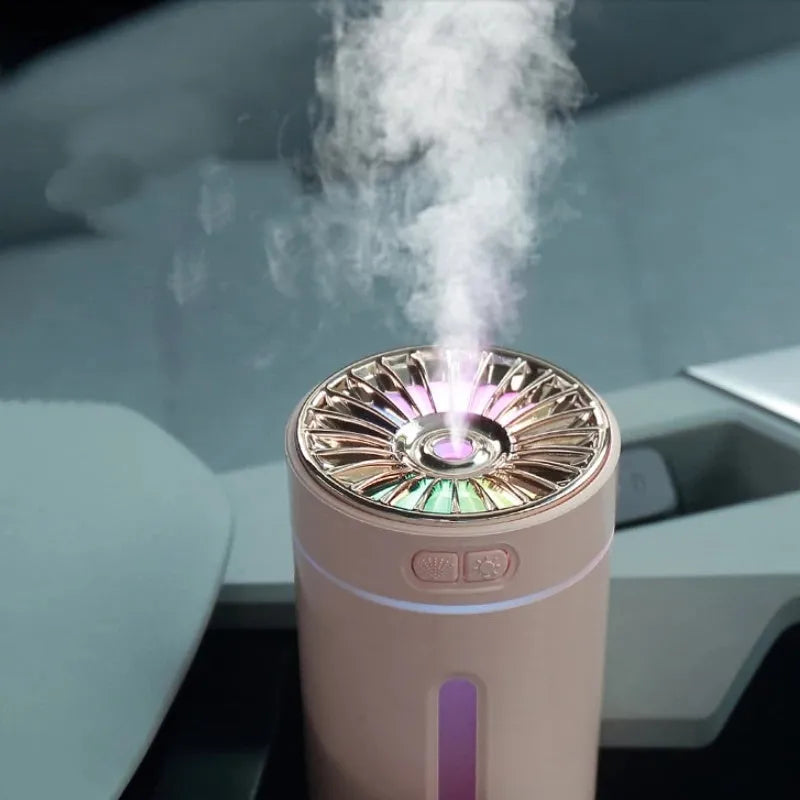 Black portable car humidifier with colourful LED lights showing mist output, placed in vehicle cup holder