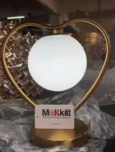 Pink heart shaped decorative LED lamp with multi-colour lights on a table