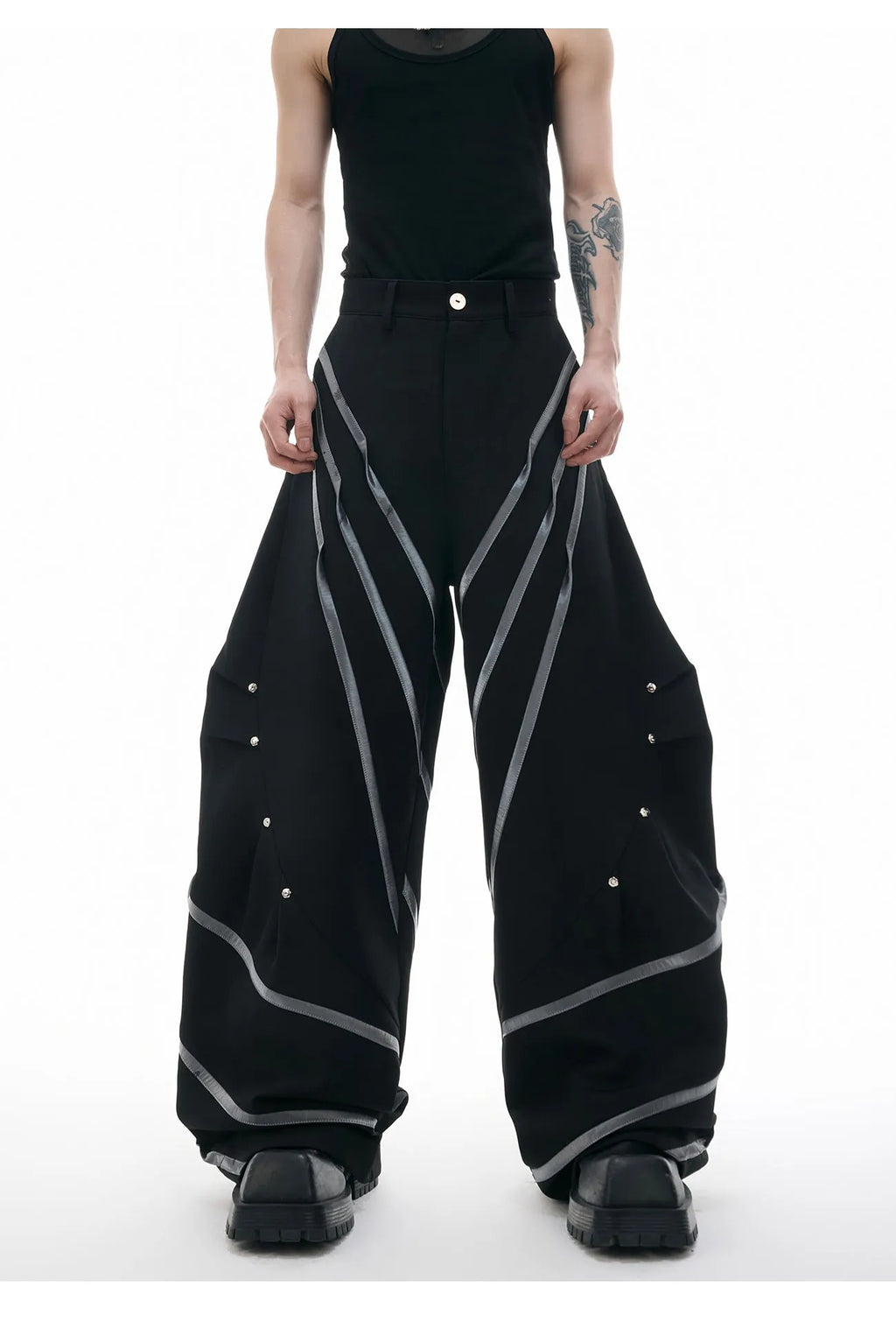 Men's black trousers with metal striped rivets and pleated design detail