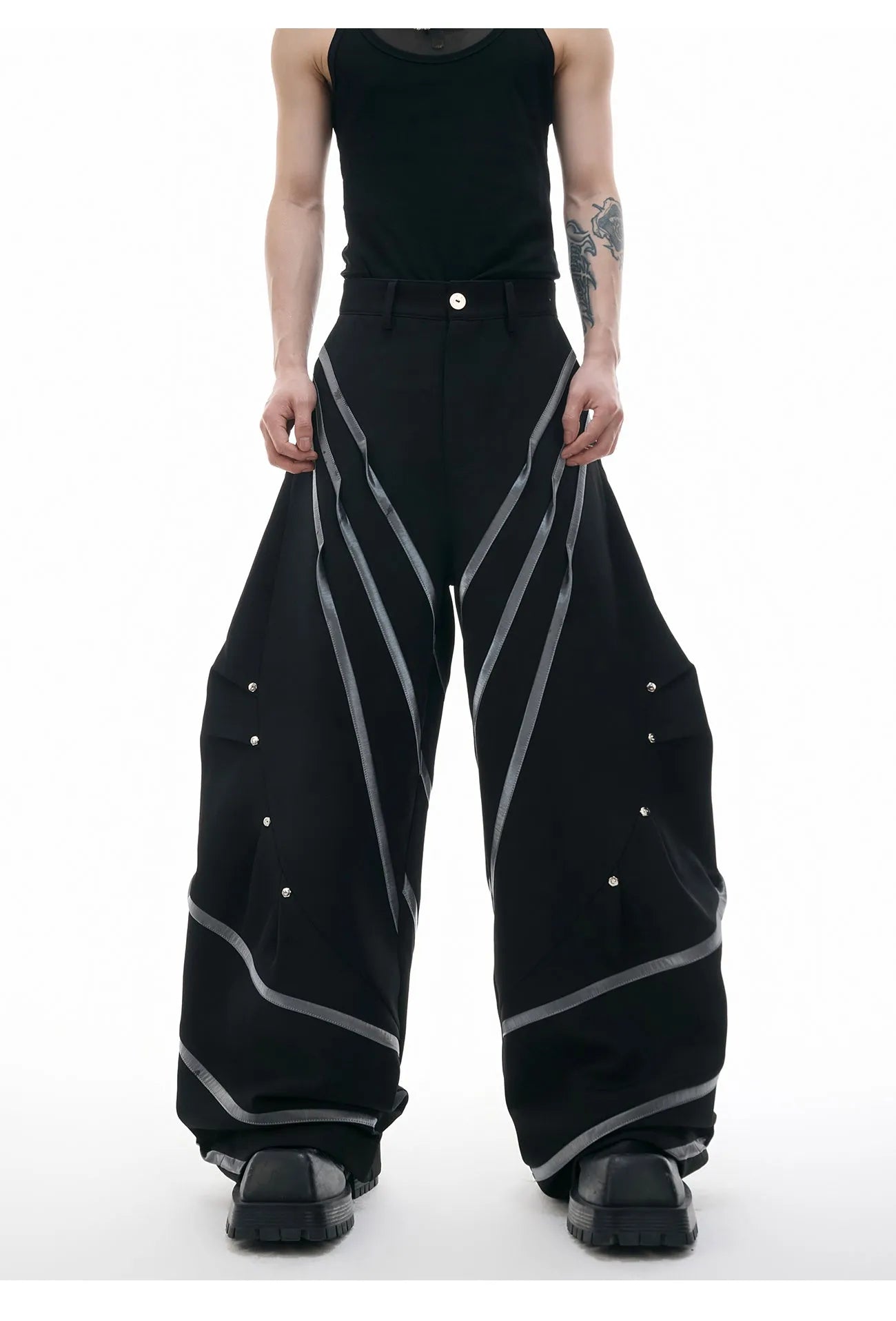 Men's black trousers with metal striped rivets and pleated design detail