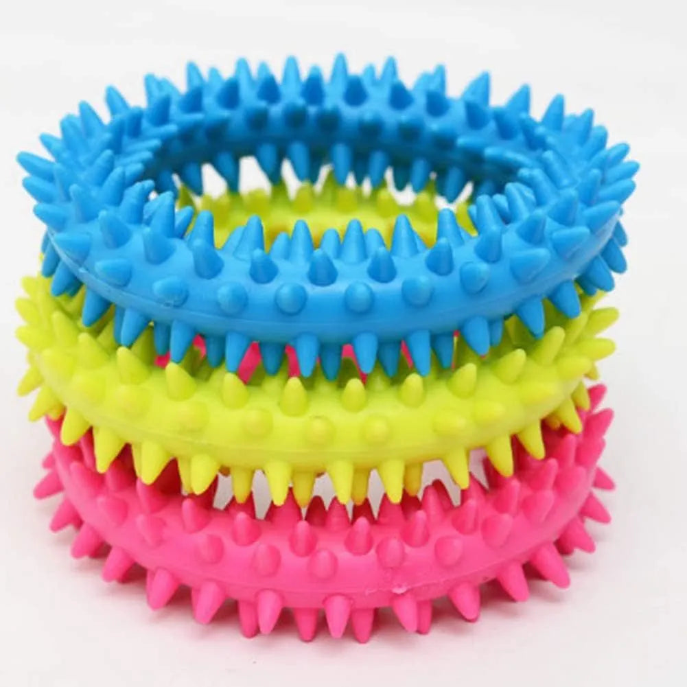 Blue TPR spiky circle dog chew toy on a white background showing dental nubs and ring shape.