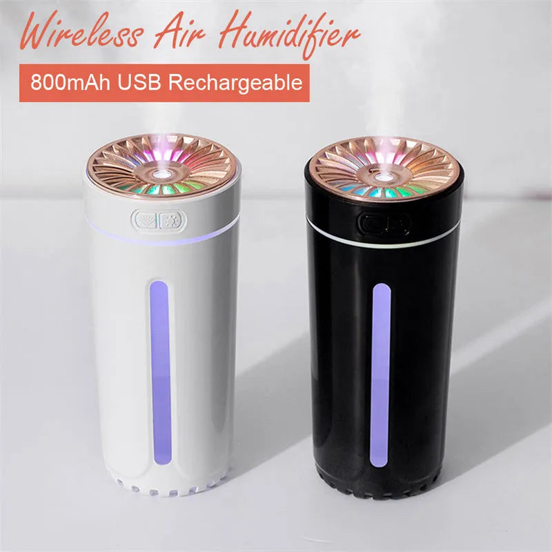 Black portable car humidifier with colourful LED lights showing mist output, placed in vehicle cup holder