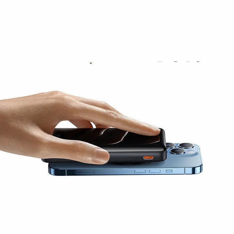 Slim blue magnetic power bank with wireless charging surface, shown next to its included USB cable.