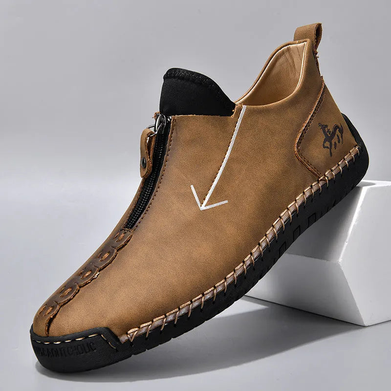 Men's black leather zip-up Martin boots with hand-stitched detail and a round toe.