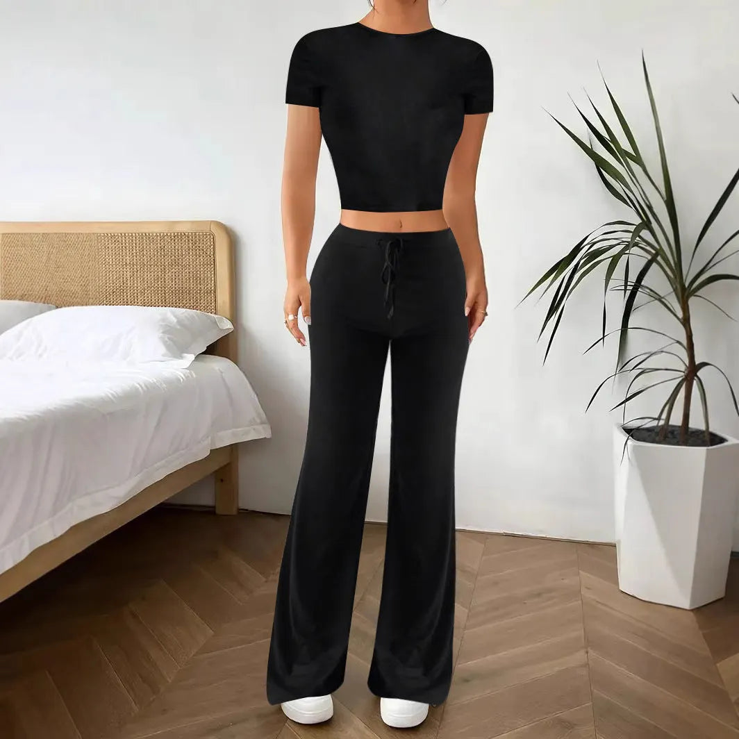 Black women's high waist trouser and short sleeve t-shirt co-ord set on a hanger.