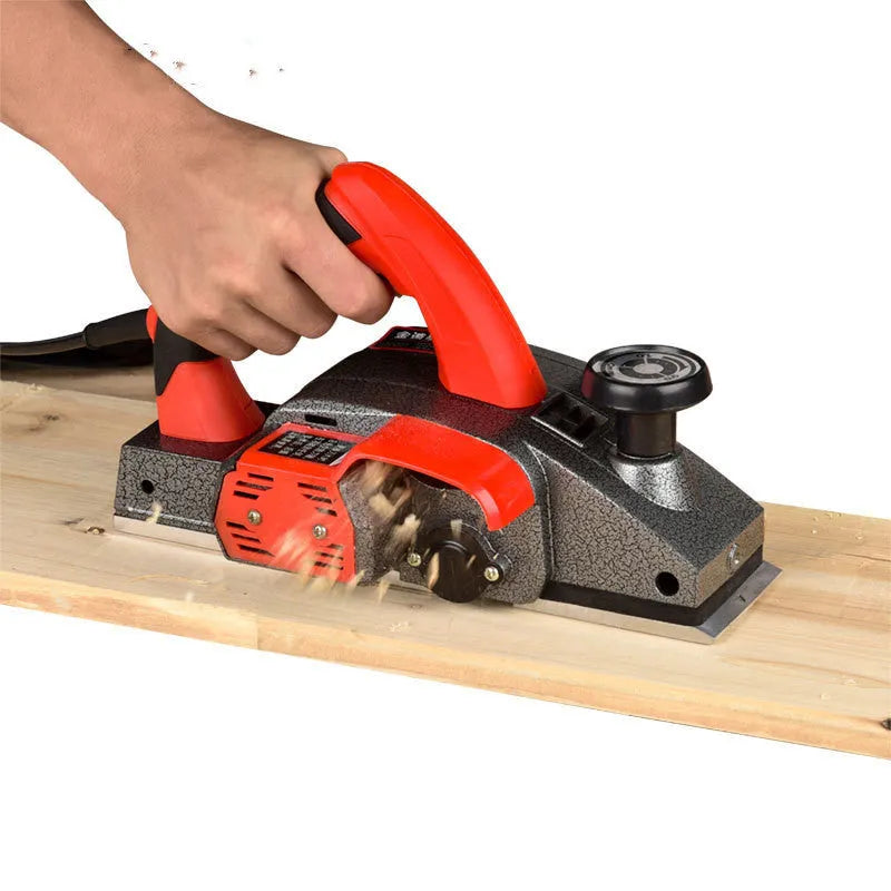 Red electric wood planer with aluminum body for carpentry and workshop use