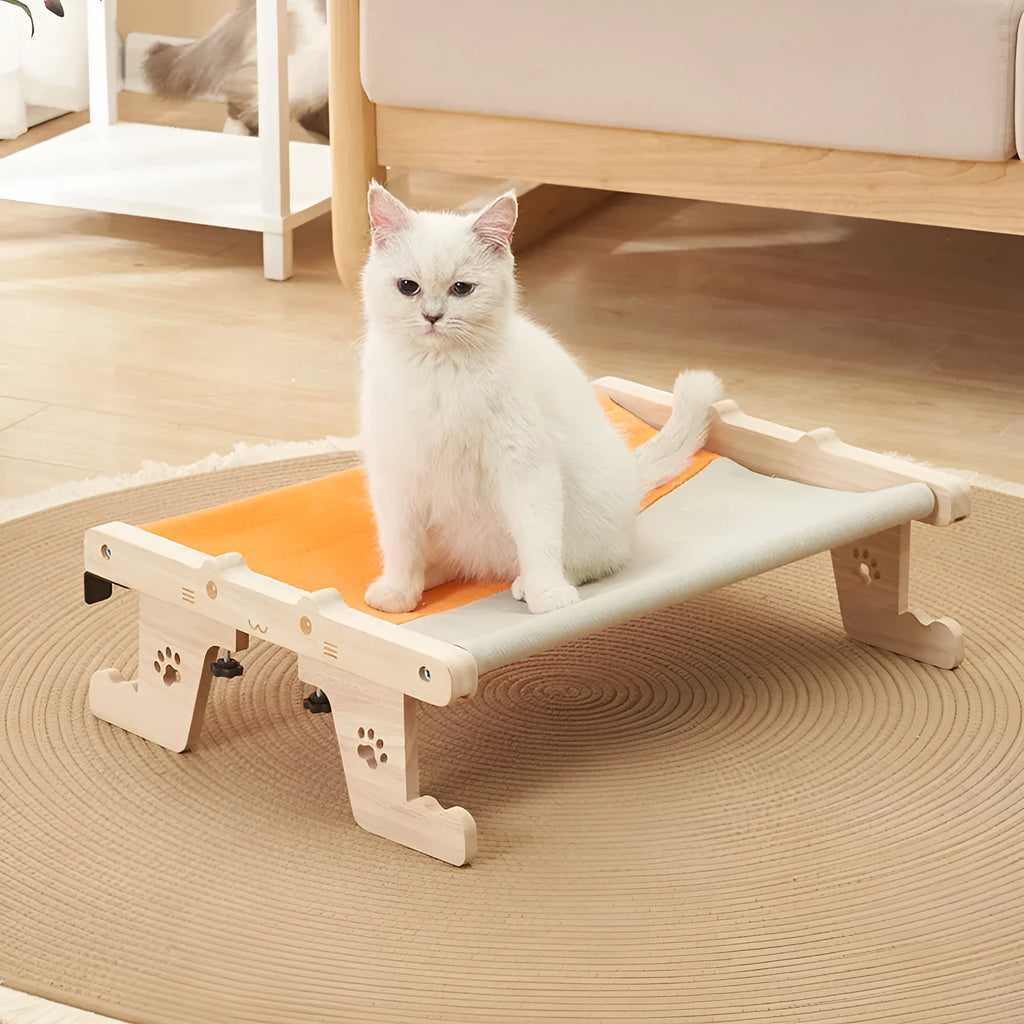 Wooden cat hanging bed hammock shown attached to a balcony railing.