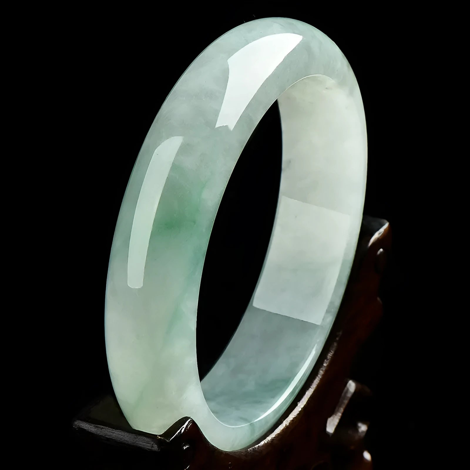 Light green jade bracelet with smooth surface showing natural stone texture