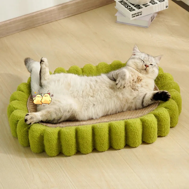 Green oval cat scratch pad bed with sisal scratching surface measuring 650x420mm