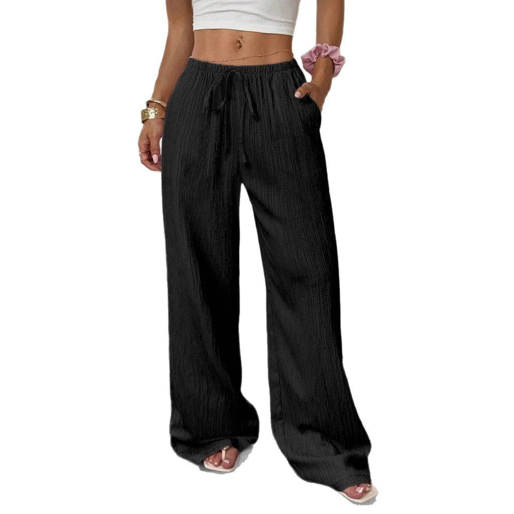 Women's black wide leg trousers with lace-up waist trimming detail showing mid-waist design
